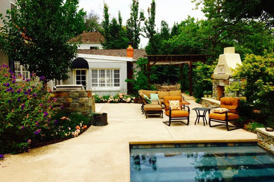 This is an example of a transitional backyard patio in Sacramento.
