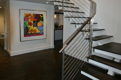 Design ideas for a mid-sized contemporary wood l-shaped staircase in New York with open risers and metal railing.