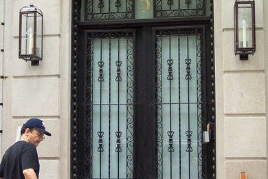 Elegant entryway photo in New York with a black front door