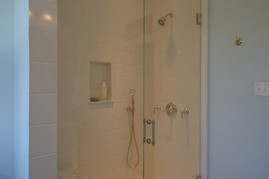 Mid-sized minimalist 3/4 white tile and stone slab marble floor bathroom photo in DC Metro with an undermount sink, furniture-like cabinets, white cabinets, quartzite countertops, a two-piece toilet and blue walls