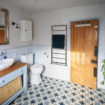 Wood panelled main bathroom with encaustic flooring and large shower