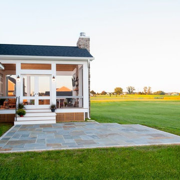 Design Builders screened porch with stone fireplace & Ipe deck in Sykesville MD