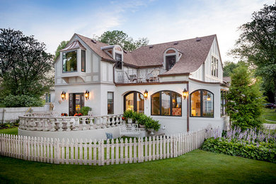 Example of a mid-sized transitional two-story stucco exterior home design in Detroit with a shingle roof