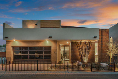 Example of a mid-sized trendy beige two-story wood exterior home design in Phoenix with a metal roof