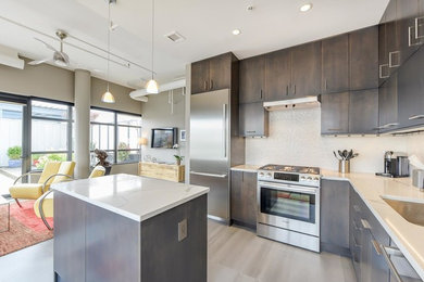 Inspiration for a large contemporary l-shaped porcelain tile and gray floor open concept kitchen remodel in DC Metro with an undermount sink, flat-panel cabinets, gray cabinets, quartz countertops, white backsplash, porcelain backsplash, stainless steel appliances, an island and white countertops