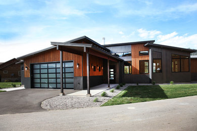Example of a mid-sized trendy multicolored one-story mixed siding house exterior design in Other with a shed roof