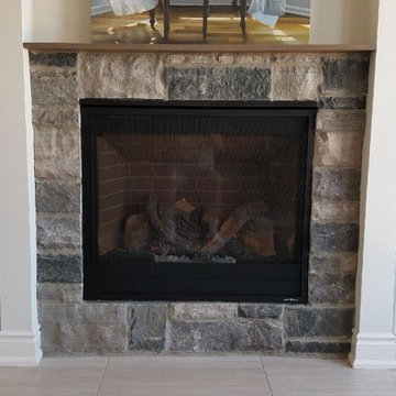 Traditional gas fireplace with stone surround