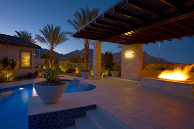 This is an example of a large contemporary full sun backyard landscaping in Las Vegas with a fire pit.