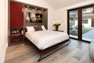 This is an example of a mid-sized contemporary guest bedroom in San Francisco with white walls, medium hardwood floors and grey floor.
