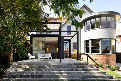 This is an example of a mid-sized contemporary backyard patio in Melbourne with concrete slab.