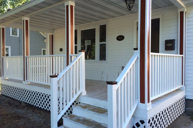 Inspiration for a timeless white two-story vinyl house exterior remodel in Other with a hip roof