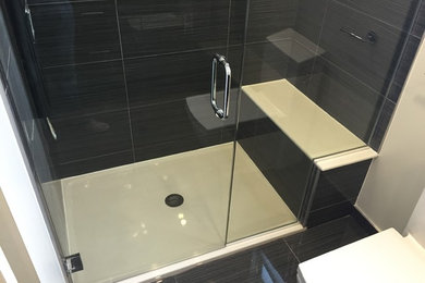Mid-sized minimalist master black tile and ceramic tile doorless shower photo in Chicago with flat-panel cabinets and a two-piece toilet