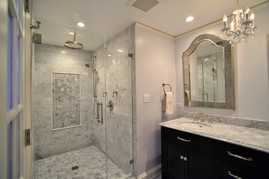 Mid-sized traditional master bathroom in Chicago with an integrated sink, furniture-like cabinets, dark wood cabinets, marble benchtops, a double shower, a one-piece toilet, white tile, white walls, pebble tile floors, stone slab, grey floor and a hinged shower door.