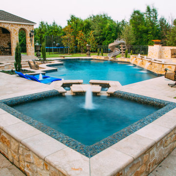 Straight line pool and spa with slide and outdoor kitchen