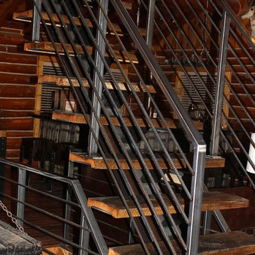 Steel floating stair case wrapped with Reclaimed wood