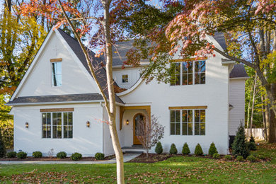 Example of a large classic white two-story mixed siding and board and batten exterior home design in Philadelphia with a shingle roof and a gray roof