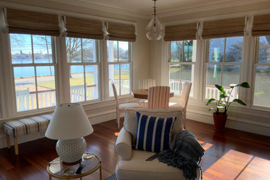 Example of a mid-sized beach style open concept family room design in Providence with beige walls and a concealed tv