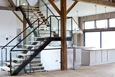 Inspiration for a mid-sized timeless u-shaped ceramic tile eat-in kitchen remodel in New York with an undermount sink, shaker cabinets, white cabinets, solid surface countertops, stainless steel appliances and two islands