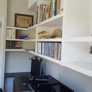 Inspiration for a small modern study in Other with white walls, lino flooring, a freestanding desk and beige floors.