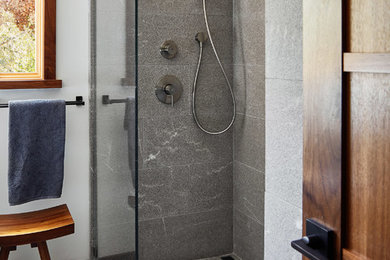 Photo of a contemporary 3/4 bathroom in San Francisco with a curbless shower, an open shower, gray tile, stone tile, white walls and grey floor.