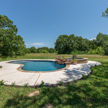 Rustic freeform pool and spa waterfall
