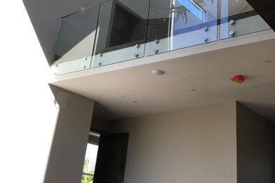Example of a trendy mixed material railing balcony design in Calgary