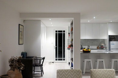 Photo of a mid-sized modern open concept living room in Sydney with white walls and painted wood floors.