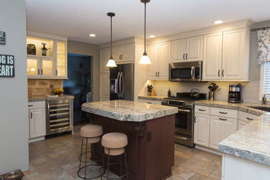 Kitchen pantry - mid-sized traditional u-shaped kitchen pantry idea in Other with an island, a single-bowl sink, raised-panel cabinets, white cabinets, granite countertops, white backsplash, subway tile backsplash and stainless steel appliances