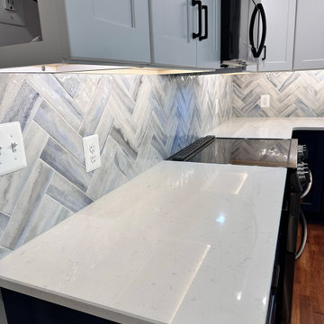 herringbone tile backsplash with white Quartz countertop