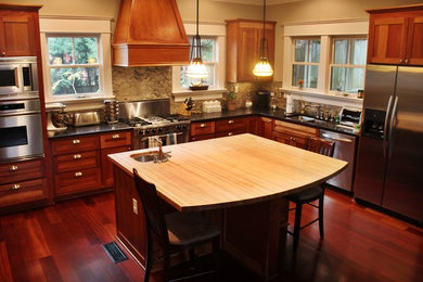 Large arts and crafts u-shaped dark wood floor kitchen photo in Atlanta with an undermount sink, shaker cabinets, medium tone wood cabinets, granite countertops, gray backsplash, subway tile backsplash, stainless steel appliances and an island