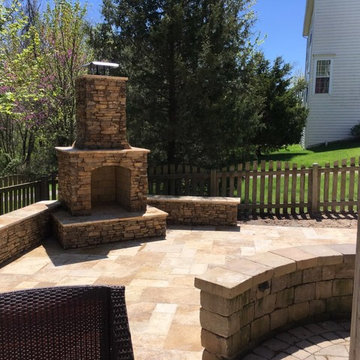 Travertine Patio with Fireplace and Seating Walls