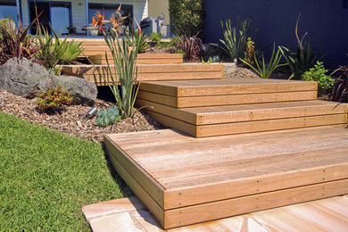 Inspiration for a beach style full sun garden in Newcastle - Maitland with decking.
