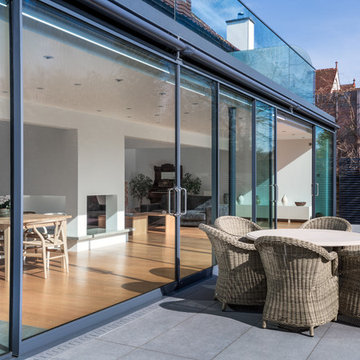 Floor to ceiling double doors open out onto a large decked area