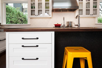 Eat-in kitchen - large 1960s u-shaped dark wood floor eat-in kitchen idea in Seattle with an undermount sink, shaker cabinets, white cabinets, wood countertops, terra-cotta backsplash, stainless steel appliances and an island