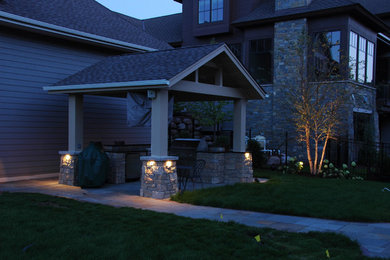 Mid-sized elegant backyard stone patio kitchen photo in Minneapolis with a gazebo