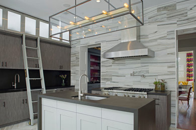 This is an example of a mid-sized contemporary single-wall eat-in kitchen in Atlanta with an undermount sink, flat-panel cabinets, grey cabinets, stainless steel appliances, marble floors, with island, grey splashback, stone tile splashback, solid surface benchtops and grey floor.