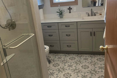 Inspiration for a mid-sized transitional master single-sink sliding shower door remodel in Other with shaker cabinets, gray cabinets, marble countertops and a built-in vanity
