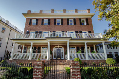 Large traditional three-storey brick apartment exterior in Raleigh with a flat roof.