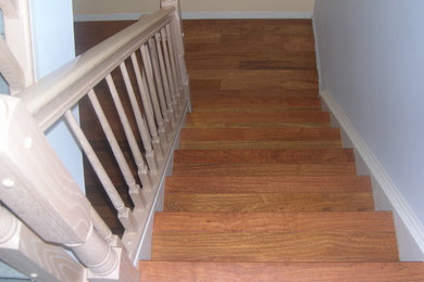 Mid-sized arts and crafts wood u-shaped staircase in New York with wood railing.