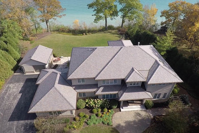 Inspiration for a large brown two-story house exterior remodel in Milwaukee with a tile roof