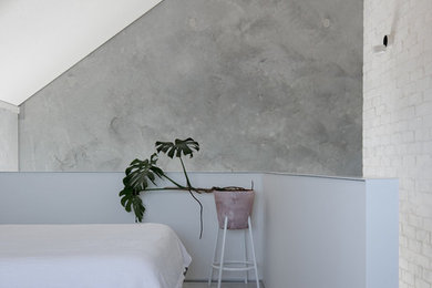 Design ideas for a contemporary loft-style bedroom in Perth with concrete floors and grey floor.