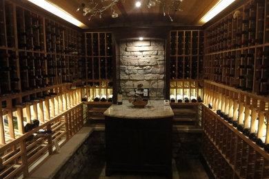 Wine cellar - mid-sized traditional slate floor and beige floor wine cellar idea in Ottawa with storage racks
