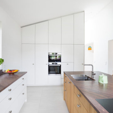 Weiße Küche mit Kochinsel mit Naturstein Granitplatte
