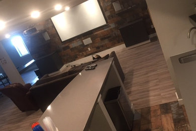 Example of a mid-sized transitional open concept home theater design in Phoenix with beige walls and a projector screen
