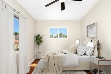 Inspiration for a mid-sized timeless guest medium tone wood floor, brown floor and coffered ceiling bedroom remodel in Los Angeles with white walls and no fireplace