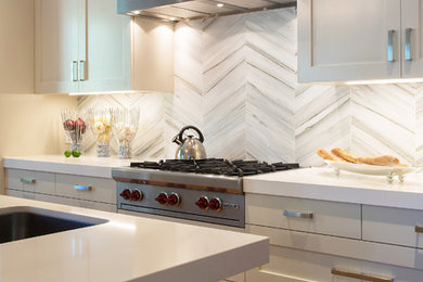 Inspiration for a mid-sized contemporary l-shaped dark wood floor and brown floor kitchen remodel in San Francisco with a single-bowl sink, shaker cabinets, white cabinets, solid surface countertops, gray backsplash, stone tile backsplash and an island