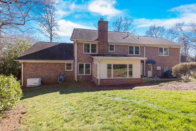 Transitional one-story mixed siding exterior home idea in Other