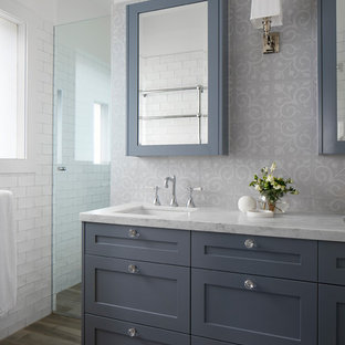 Inspiration for a mid-sized transitional 3/4 multicolored tile and subway tile plywood floor and brown floor bathroom remodel in Melbourne with furniture-like cabinets, gray cabinets, white walls, an integrated sink, marble countertops and white countertops