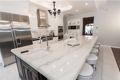 Inspiration for a large timeless single-wall marble floor and white floor eat-in kitchen remodel in Other with raised-panel cabinets, white cabinets, marble countertops, multicolored backsplash, mosaic tile backsplash, an island, a farmhouse sink and stainless steel appliances