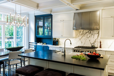 Inspiration for a large contemporary l-shaped medium tone wood floor and brown floor open concept kitchen remodel in Toronto with a farmhouse sink, recessed-panel cabinets, white cabinets, marble countertops, white backsplash, marble backsplash, stainless steel appliances, an island and white countertops